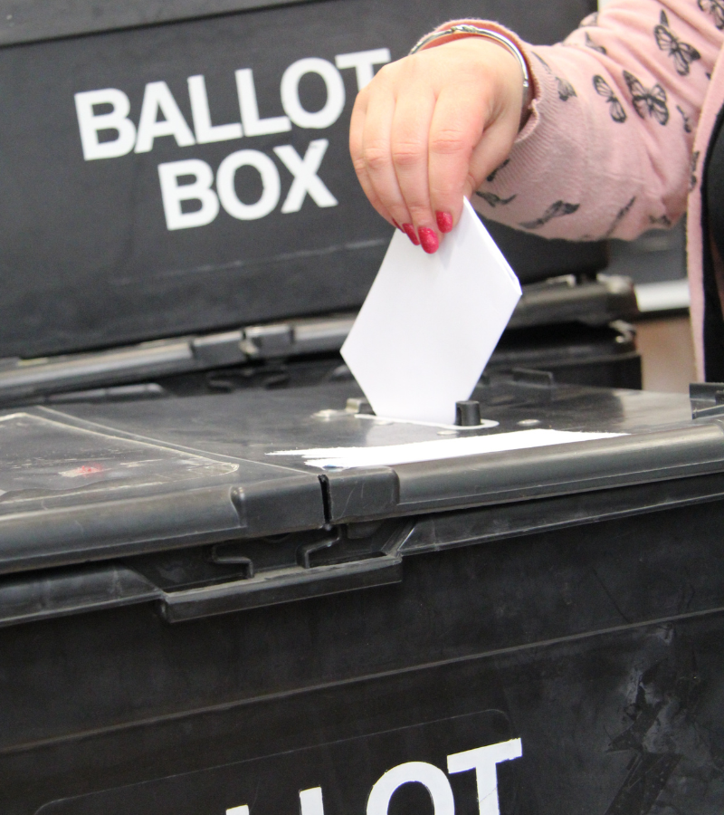 Hand next to ballot box