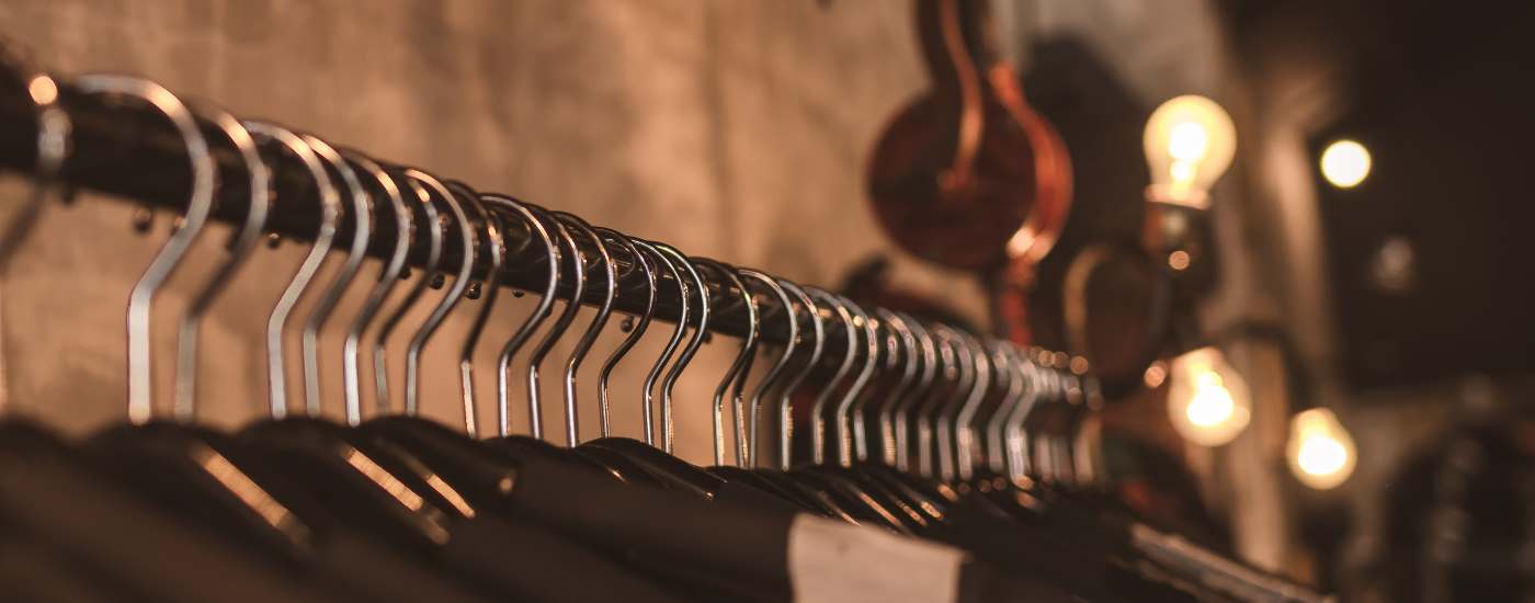 Clothes hangers hanging on a rail in a shop