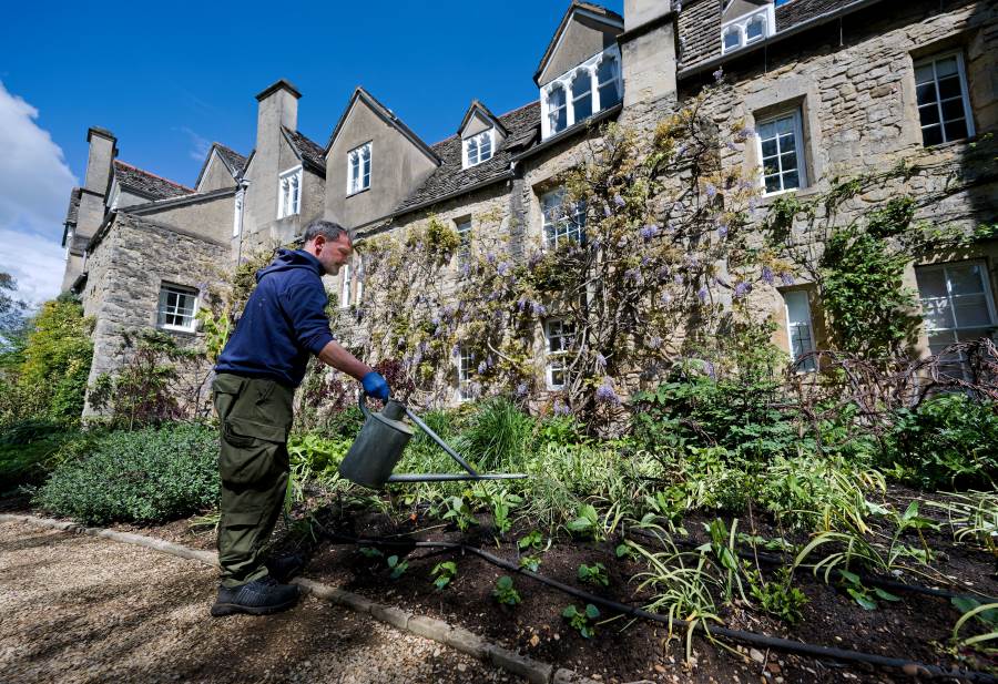 Exterior view of Worcester College showing a gardener tending to plants.