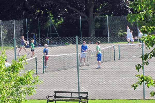 People playing tennis in Cutteslowe Park