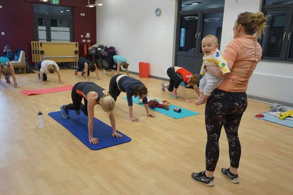 People on mats in activity class for families