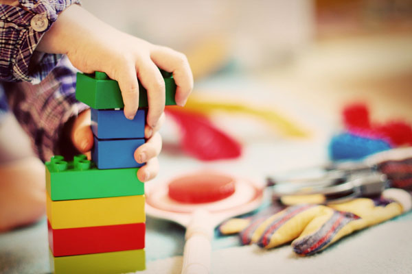 Toddler playing with toy bricks