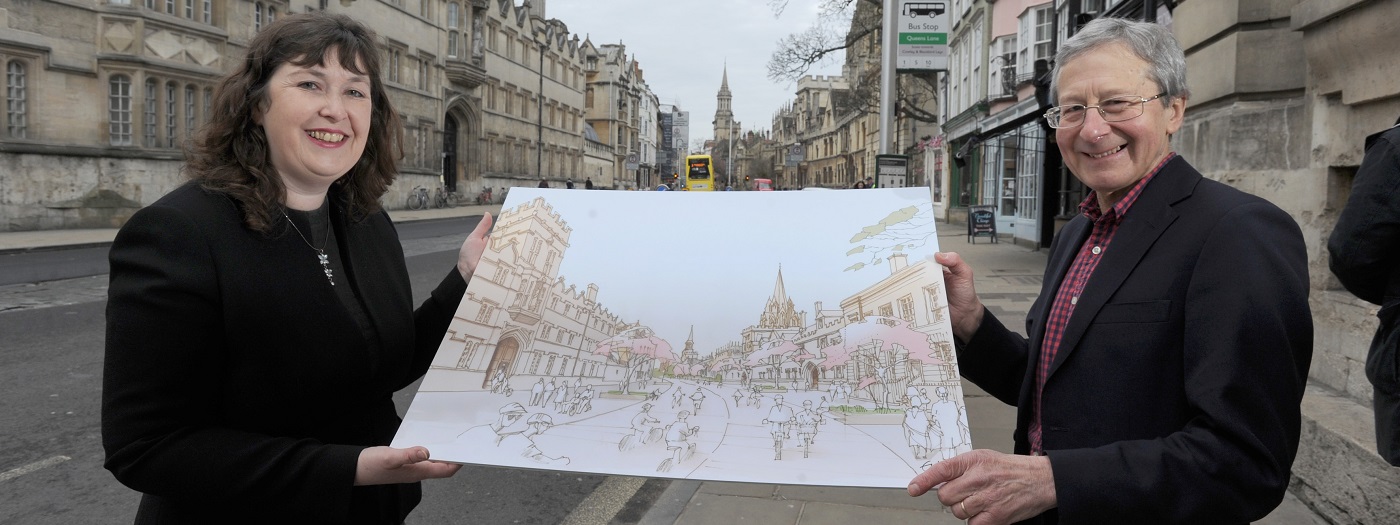 Image showing Councillors Susan Brown and Bob Price in High Street holding up an artist's impression of what the road could look like in 2050.