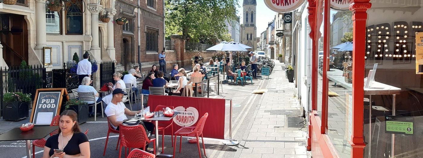 Image showing people eating and socialising in the outdoor dining space created in St Michael's Street in 2022