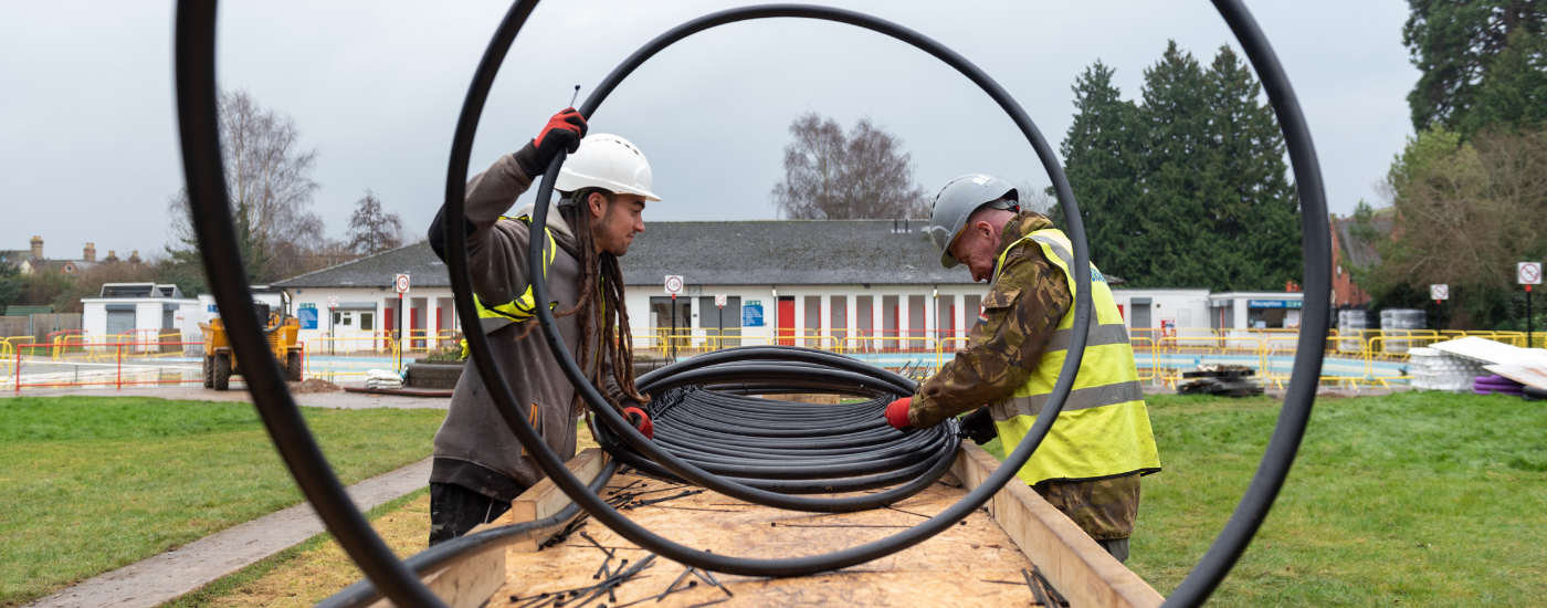 Image of spiral cable being installed by two workers