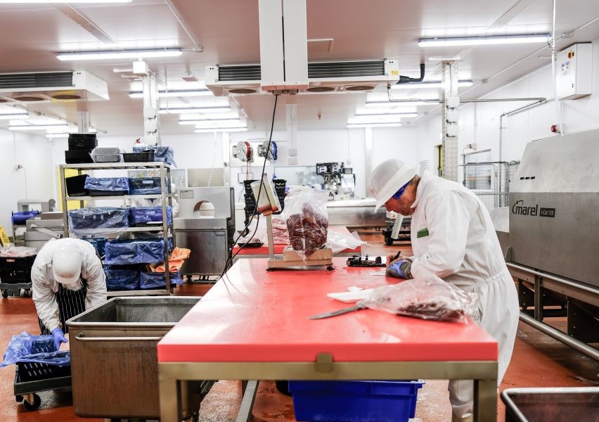 Workers in Aldens factory preparing food