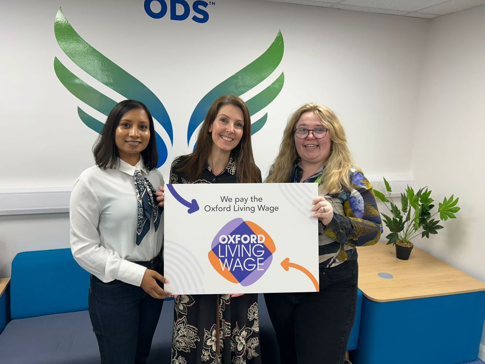 ODS employees holding an Oxford Living Wage board