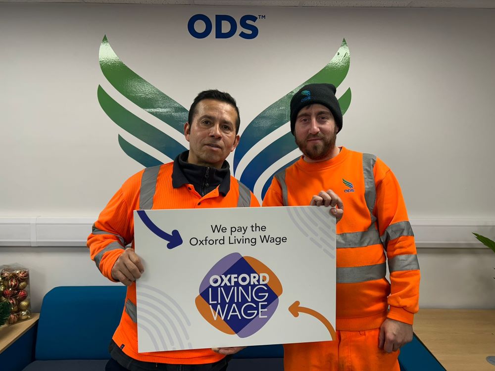 Employees from ODS pose with Oxford Living Wage sign